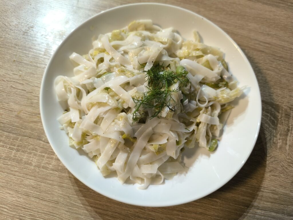 A bowl with rice noodles and carmelized fennel